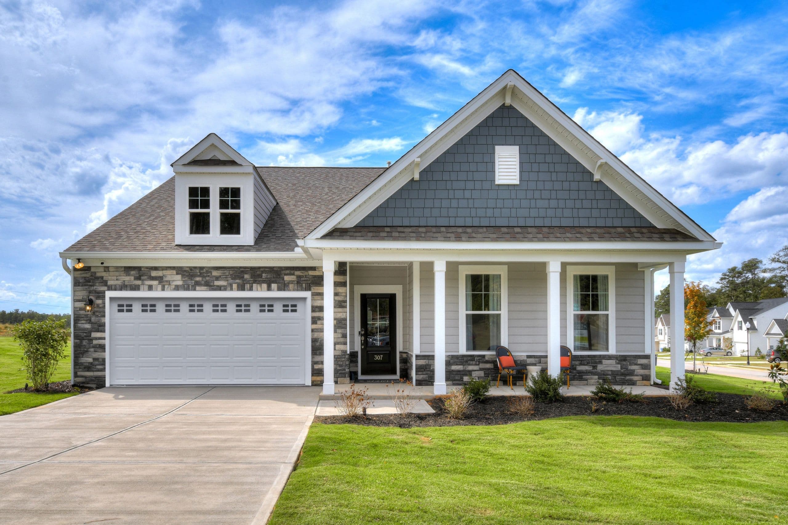 Stanley Martin Easton model home — craftsman exterior with stone accents and covered front porch